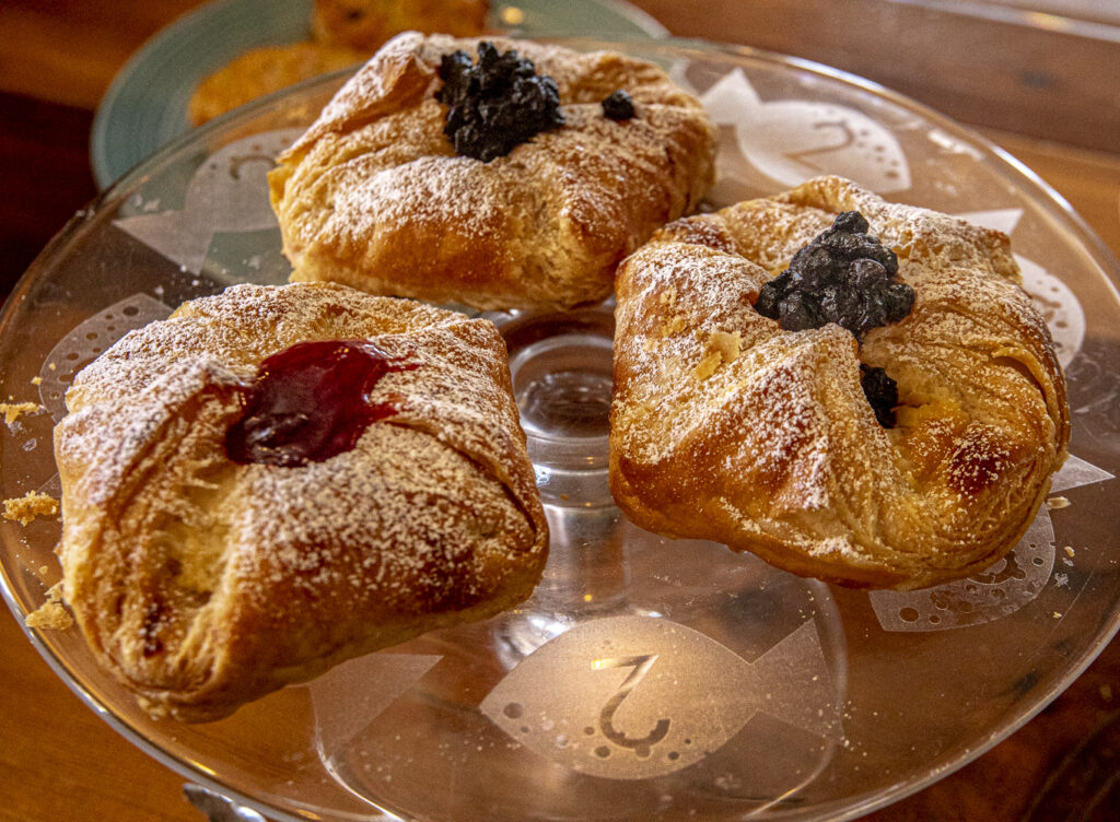 Three pastries on a glass plate.